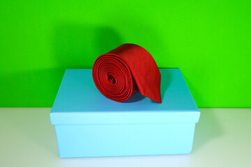 A necktie rolled on gift box closeup view 