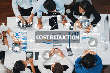 Discover a team of diverse professionals engaged in cost reduction strategies using digital tools...