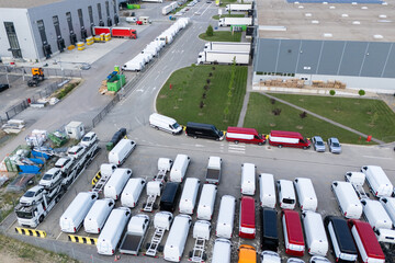 Aerial view of a new delivery vans parking lot at a logistics hub © scharfsinn86