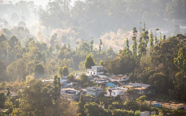 Fototapeta premium Beautiful morning view of Kodaikanal hills and village nestled in lush greenery
