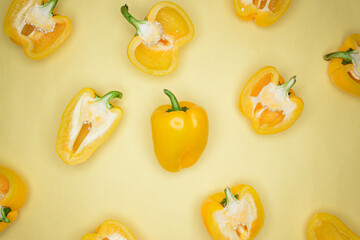 Flat lay photo of sweet yellow Bulgarian peppers on the yellow background.