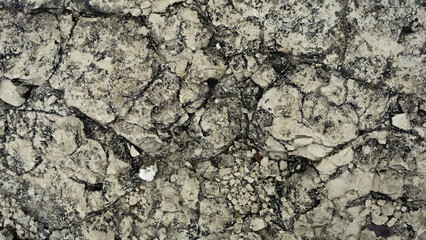 Rock texture background with rough and cracked stone layers