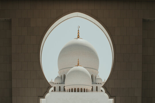 Sheikh Zayed Grand Mosque domes framed by ornate Islamic architecture in Abu Dhabi