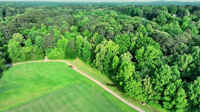 aerial footage of Logan Farm Park with lush green trees and grass in Acworth Georgia USA