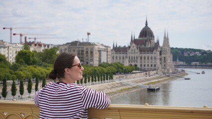 young woman in sunglasses on hungarian parliament background