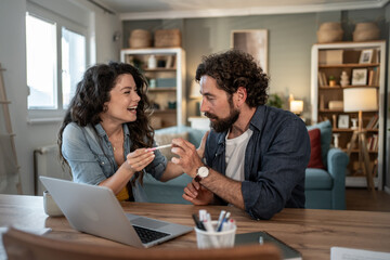 Happy couple looking at pregnancy test result at home