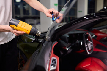 The Professional Windshield Tinting Process Conducted in a Modern Auto Showroom Environment
