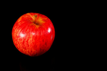 Apple isolated on black background closeup view copy space  