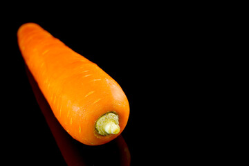 fresh carrot on black background closeup view 