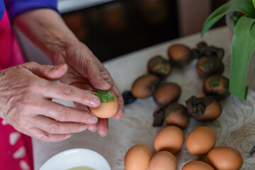 Preparing eggs with natural dye for traditional Easter celebration in a home setting