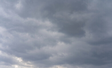 Dark gray clouds gather in the sky, signaling an approaching storm during late afternoon
