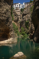 View from Water Mine in Ronda. Below View of Green River, Steep Cliffs and Buildings on Rock in Spain.