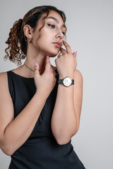 Portrait of a beautiful teenage girl in a black dress. Half Body portrait.