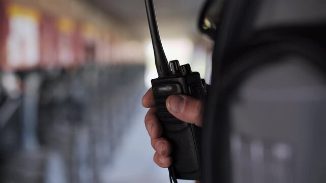 A walkie talkie in the hands of a worker