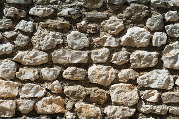 Natural stone wall texture background for construction, renovation, or design projects. Suitable for architectural, historical, or decorative purposes.