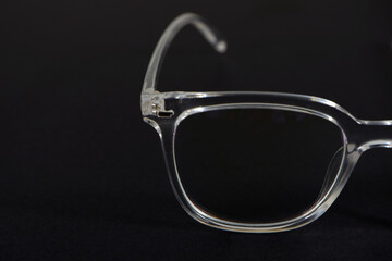transparent eye wear on black background closeup view 