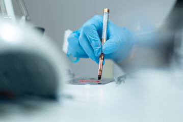 A nail technician making color, very clean desk setup