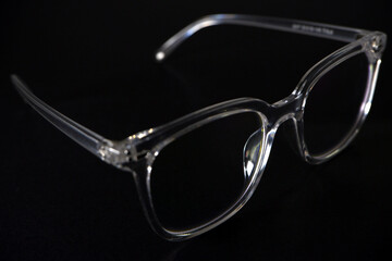 transparent eye wear on black background closeup view 