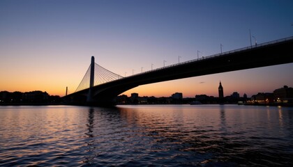 Fototapeta premium Serene Contemporary Bridge at Sunset Over Calm Water