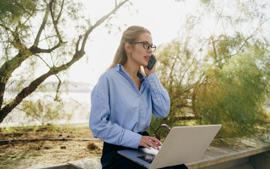 A Young Professional Engaging in Work Remotely While Surrounded by Beautiful Nature