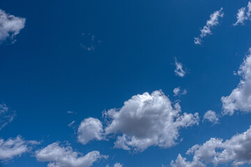 white cumulus clouds in blue sky. 
