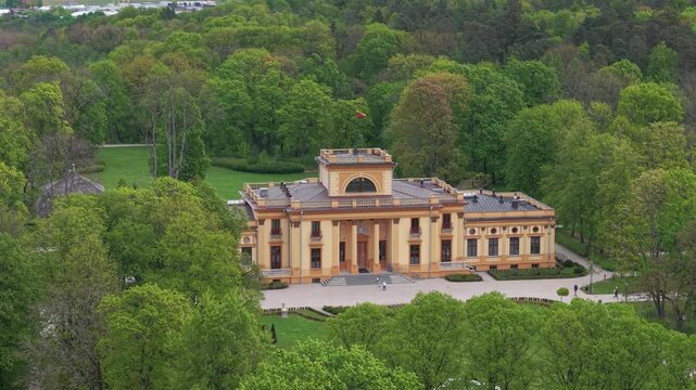 Drone footage of a Traku Voke Manor heritage museum in Vilnius, Lithuania with green lush landscape