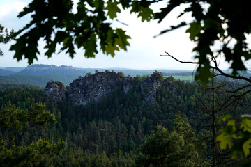 A serene nature reserve featuring rugged cliffs and dense forest, capturing the untouched beauty of...