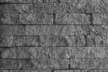 Texture of a wall made of construction foam blocks. Fashionable background of a brick wall for designers. Bricks for facade decoration. Gray brick wall.