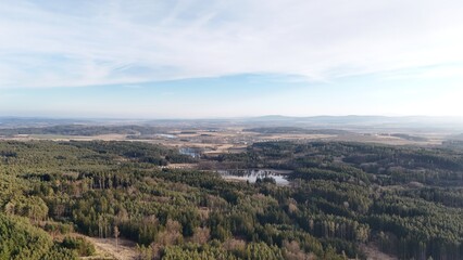 Aerial view of a vast forest canopy, revealing the natural patterns and textures of untouched wilderness. A breathtaking perspective on Earth’s green beauty from above.

