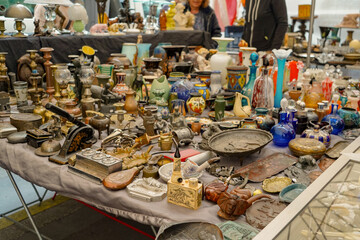 vintage items on sale in a flea market on a sunny day in the streets of Paris , France