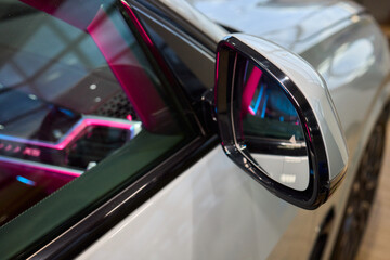 An elegant closeup shot of a sleek car side mirror showcasing its design and details