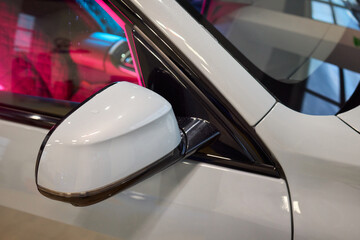 An elegant closeup shot of a sleek car side mirror showcasing its design and details