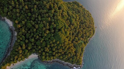 Verdant island rising from turquoise waters, tropical greenery glowing under warm sunset lighting, peaceful oceanic landscape