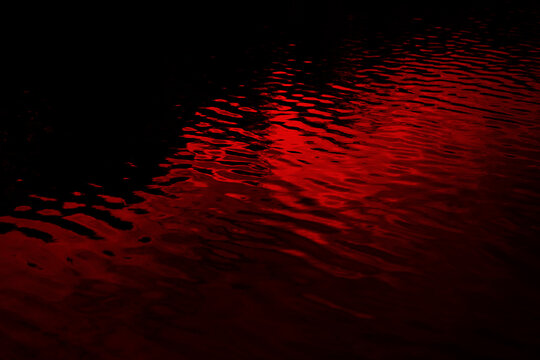 Black dark garnet red abstract background. Light reflection on water surface. Blood red sunset, night. Copy space for design. Web banner. Nightmare fantasy mysterious scary dramatic. Contrast.