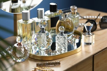 Bottles of perfumes on wooden table indoors