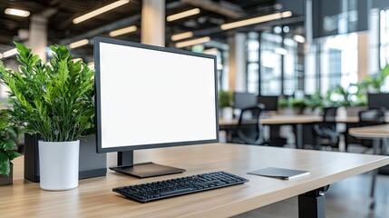 Modern office workspace with computer and plants.