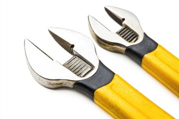 Two adjustable wrenches with yellow handles.