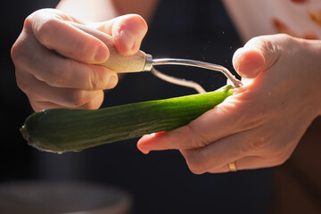A Detailed Scene of Peeling a Cucumber