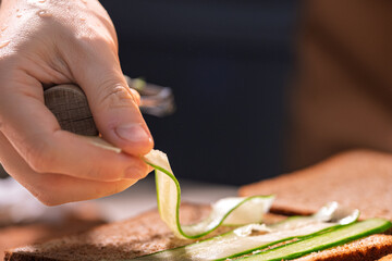 Hand Slicing Cucumber with a Knife Blade