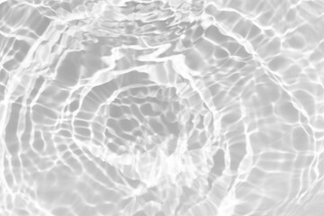 White water with ripples on the surface. Defocus blurred transparent white colored clear calm water surface texture with splashes and bubbles. Water waves with shining pattern texture background.