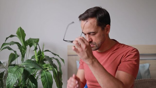 Man touches bridge of nose and head due to headache and feeling unwell, sinusitis