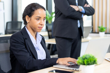 African american business woman working with laptop in modern meeting room. Multi-Ethnic Corporate Business Meeting. Female executive handling real estate project. Financial analysis.