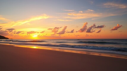 A breathtaking sunrise paints the sky with vibrant orange and pink hues over a tranquil beach with gentle waves lapping the shore.