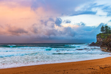 Moody sunrise with waves at the seaside