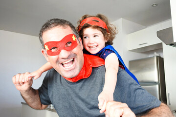 Superhero father and  daughter pretent palying fun together