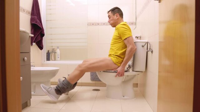 Man struggles with painful diarrhea in bathroom