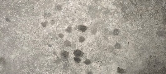 Stains of engine oil from cars that drip onto the floor in the parking lot