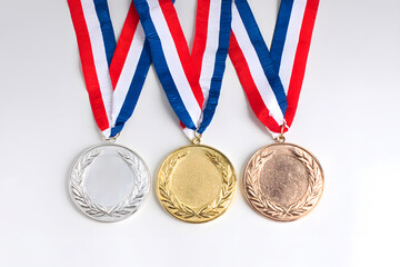 Three unique medals showcasing various achievements, beautifully isolated against a crisp white background.