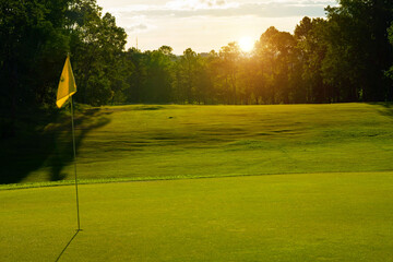 Beautiful golf course in a sunny day. Background evening golf course has sunlight shining down.