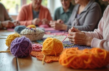 Elderly women friends gather in cozy crochet club. Ladies knit colorful wool threads. Creative hobby, needlecraft, handmade textile art on wooden table. Handmade friendship, leisure time, cozy